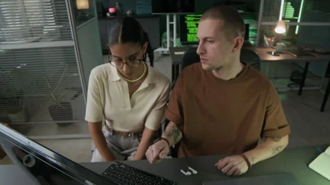 Young Male Programmer Checking Work of His Junior Female Colleague Stock Footage 292632088