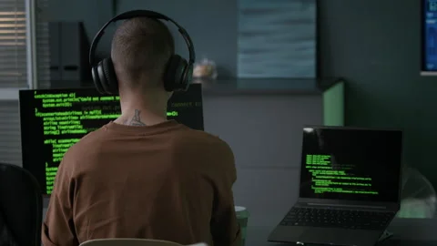 Young Male Programmer in Headphones Typing Program Code in Night Office Stock-Footage 292622357