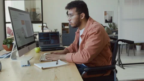 Young Male Programmer in Wheelchair Testing Software Algorithm Stock Footage 293171290