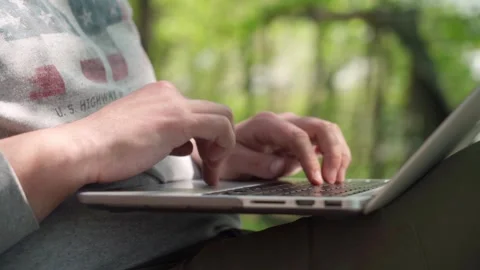 A young male programmer working at a computer outdoors. Stock Footage 241177914