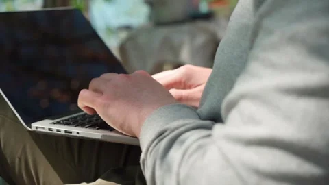 A young male programmer working at a computer outdoors. Stock Footage 241493084