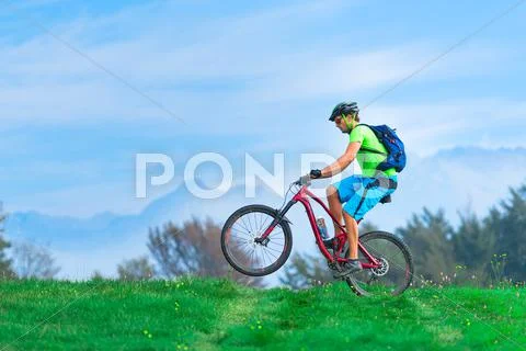 A young male riding a mountain bike outdoor .with soaring Stock Photos