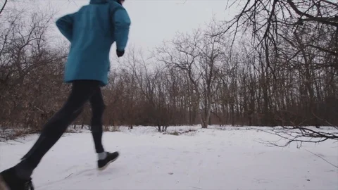 Young male runner in winter park Stock Footage 85385580