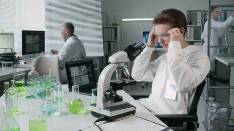Young Male Scientist Analyzing Samples at Desk in Lab Timelapse Stock Footage 330677266