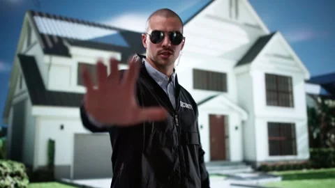 Young Male Security Guard Making Stop Gesture In Front Stock Footage 294728557