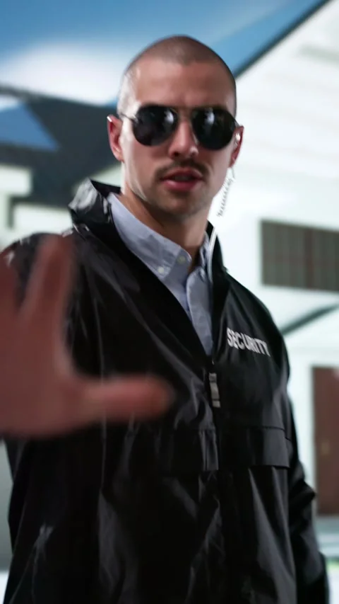 Young Male Security Guard Making Stop Gesture In Front Stock Footage 296932381