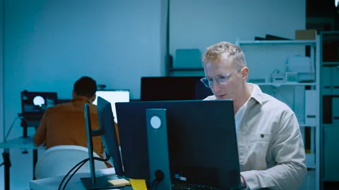 Young male software developer typing and reviewing code while designing web.. Stock Footage 337043595
