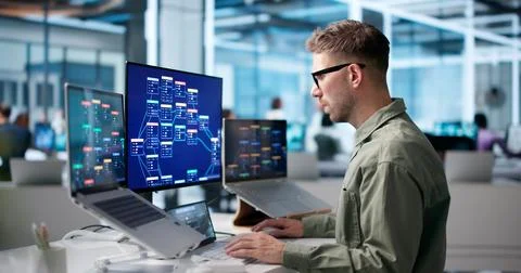 Young Male Software Developer Uses Low Code Platform On Laptop. Stockfoto's
