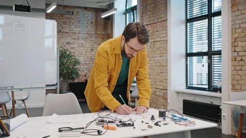 Young male startupper develops device prototype in office Stock Footage 219856831