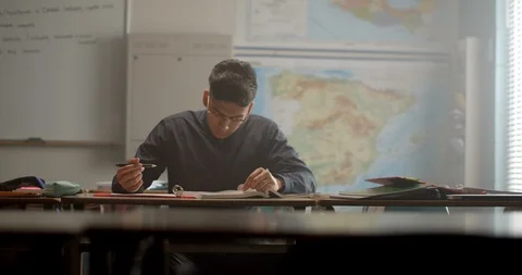 Young male student in class writing and working homework 스톡 동영상 118141015