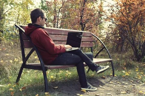 Young male student programmer work study outdoors. Programmer developer works Stock Photos