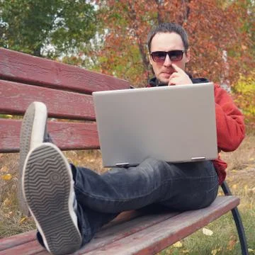 Young male student programmer work study outdoors. Programmer developer works Stock-Fotos