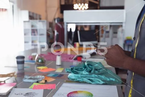 Young male student using smartphone at a fashion college Stock Photos