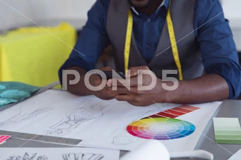 Young male student using smartphone at a fashion college Stock Photos