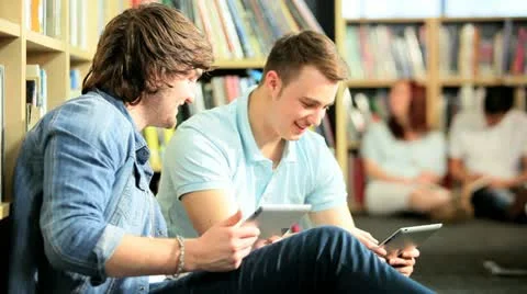 Young male students networking on tablets in university   Stock Footage 10895340