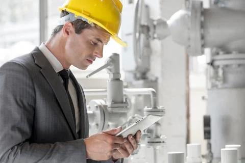 Young male supervisor using tablet PC in industry Stock Photos
