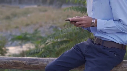 Young male typing a text message and calling outdoors Stock Footage 140287111