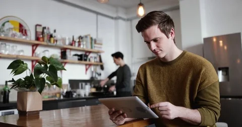 Young male using digital tablet at home Stock Footage 85208975