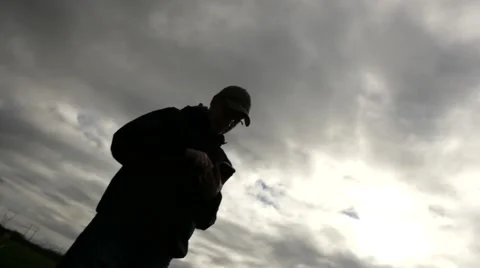 Young male using smartphone cloudy sky Stock Footage 61745595