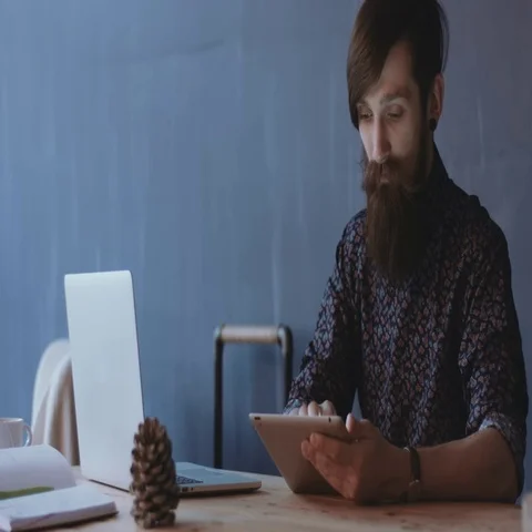 Young male using tablet at desktop Stock Footage 69287089