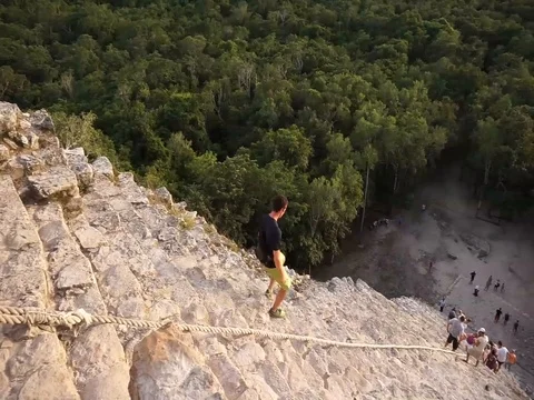 Young Male walking down the steep steps at the Coba Maya Ruin in Mexico. Stock Footage 100471571