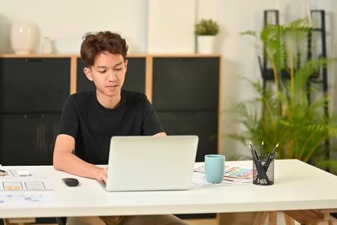 Young male web developer planning application template layout framework for Stockfoto's