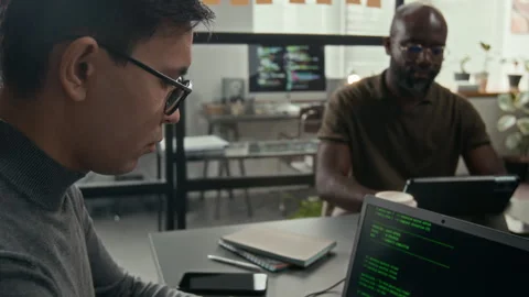 Young Male Web Developer Wearing Glasses Programming on Laptop in IT Office Stock Footage 329611436