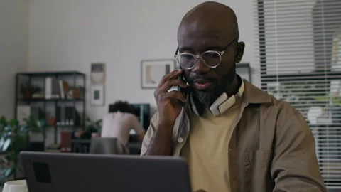 Young Male Web Engineer Speaking on Phone and Gesticulating during Workday Stock Footage 299238414