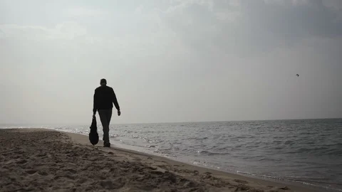 Young man 20 years old walks along the coast of the Baltic Sea with a backpack Stock Footage 109160152