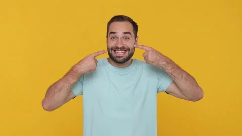 Young man 20s in basic casual blue t-shirt look camera charming toothy Stock Footage 148286830