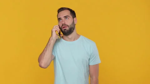 Young man 20s in basic casual blue t-shirt isolated on yellow background in Stock Footage 148290522
