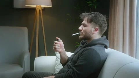 Young man about to smoke a cigarette but changes his mind and throws it awa.. Stock Footage 307467701