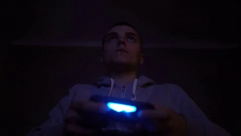 Young Man Absorbed In Online Video Game at night. Controller, console, gamepad Stock Footage 73751136