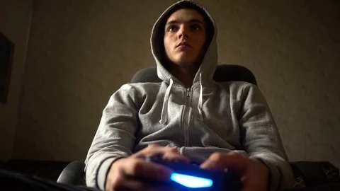 Young Man Absorbed In Online Video Game. Controller, console, gamepad Stock Footage 73752494