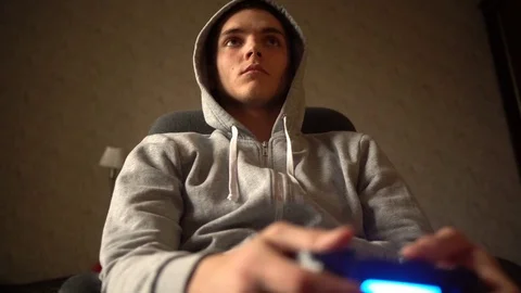 Young Man Absorbed In Online Video Game. Controller, console, gamepad Stock Footage 73752805