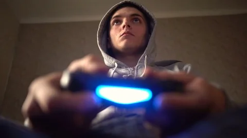Young Man Absorbed In Online Video Game. Controller, console, gamepad Stock Footage 73752918