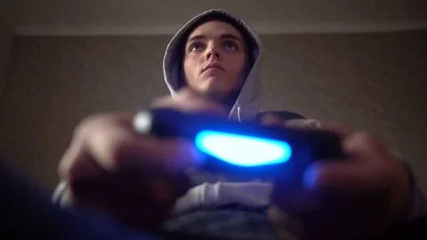 Young Man Absorbed In Online Video Game. Controller, console, gamepad Stock Footage 73753203