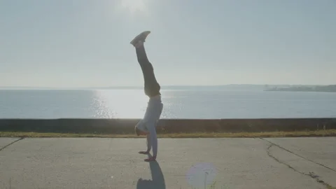 Young Man Acrobat Is Walking On Hands Stock Footage 166502870