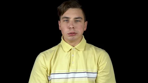 The young man actively shakes his head. A man twirls his head and his lips are Stock Footage 123314783