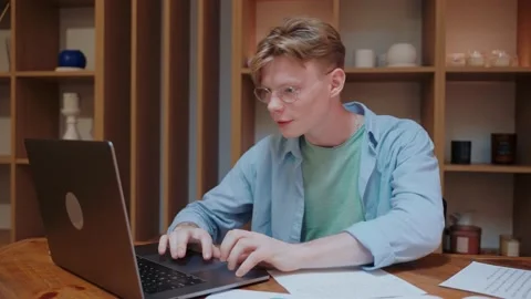 Young man actively typing on the laptop, working from home Vídeo Stock 164372909