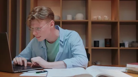 Young man actively typing on the laptop, working from home Vídeo Stock 164374564