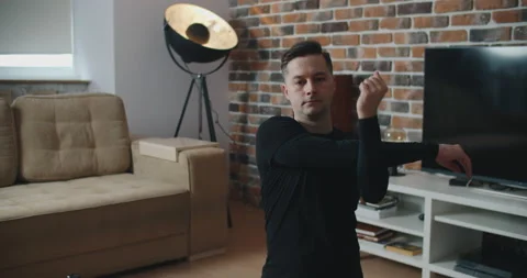 Young man in activewear doing exercise during workout at home Stock Footage 151922660