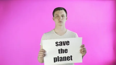 Young Man Activist With Save The Planet Poster on pink background Stock Footage 111869158