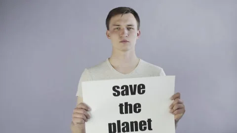 Young Man Activist With Save The Planet Poster on grey background Stock-Footage 130992050