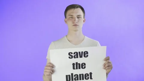 Young Man Activist With Save The Planet Poster on Violet background Stock Footage 130994754