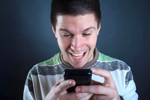 Young man addicted to his smart phone Stock Photos