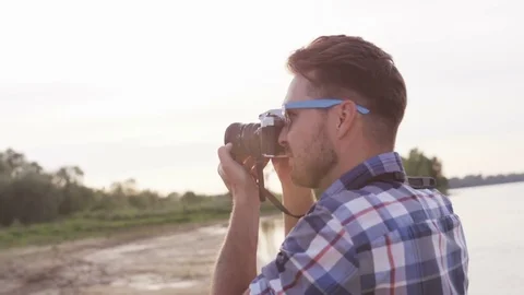 Young Man Adjusting the Camera and Moving it Down Stock Footage 76467968