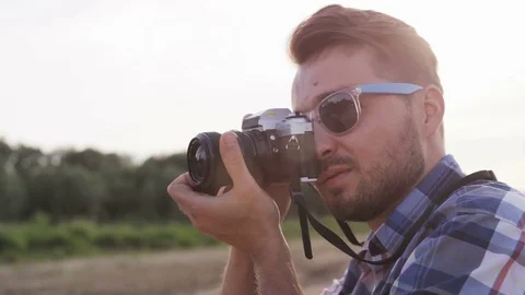 Young Man Adjusting the Camera in the Wild Stock Footage 76468101