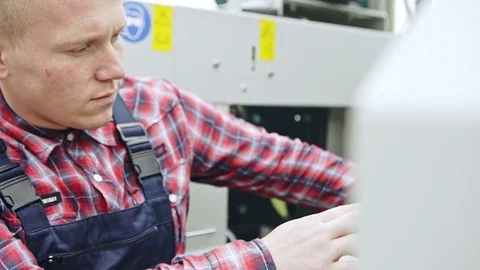 Young man adjusting industrial machine Video stock 82649270