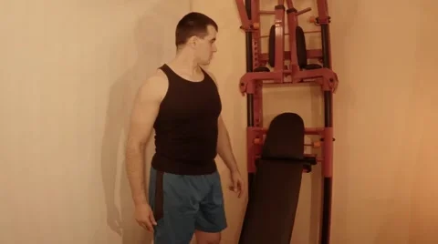 Young Man Adjusts Position of Boards on Wall Bars Stock Footage 62473147
